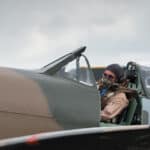 Pilot in World War 2 vintage British Spitfire fighter plane