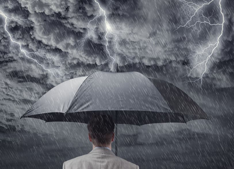 man holding umbrella in a storm