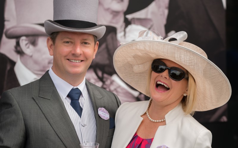 Man and a woman wearing hats at Royal Ascot
