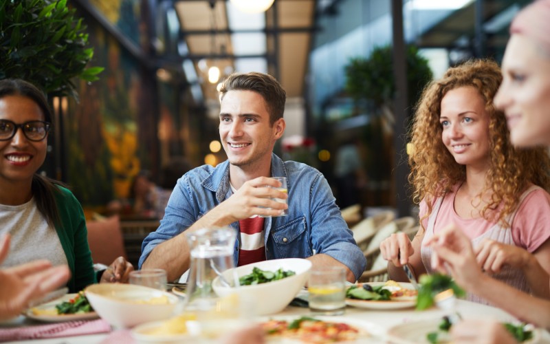 Freinds enjoying a meal around a table