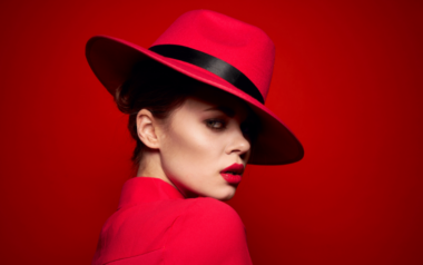 Woman wearing red outfit and red fedora hat