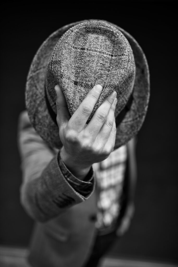 man taking his hat off