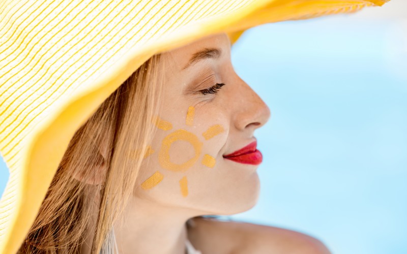 Woman wearing yellow summer hat