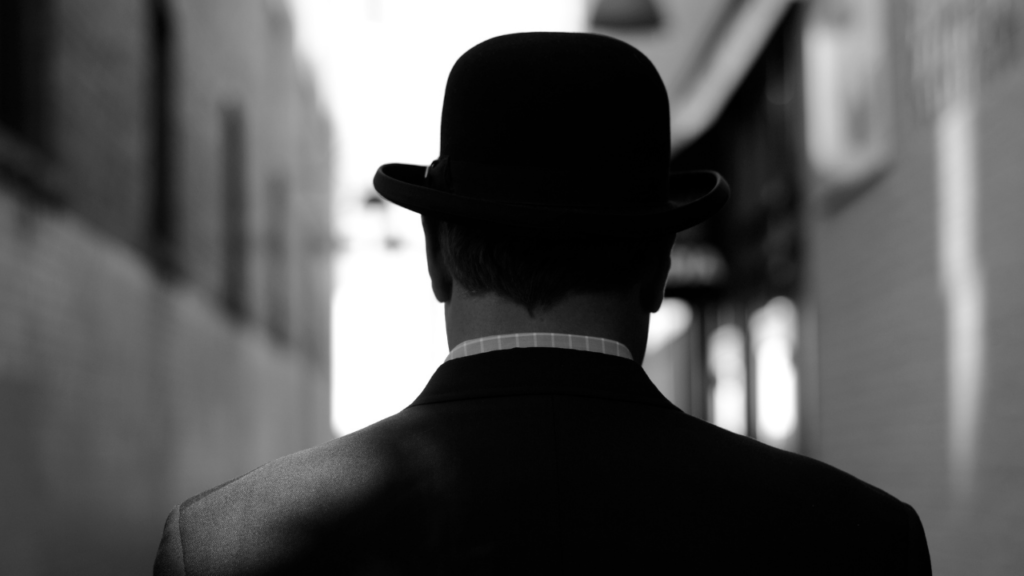 man wearing bowler hat from behind