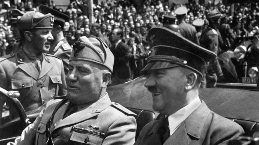 Hitler wearing cap next to Mussolini