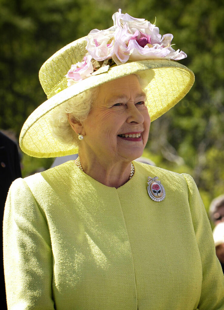 Queen Elizabeth II wearing yellow hat