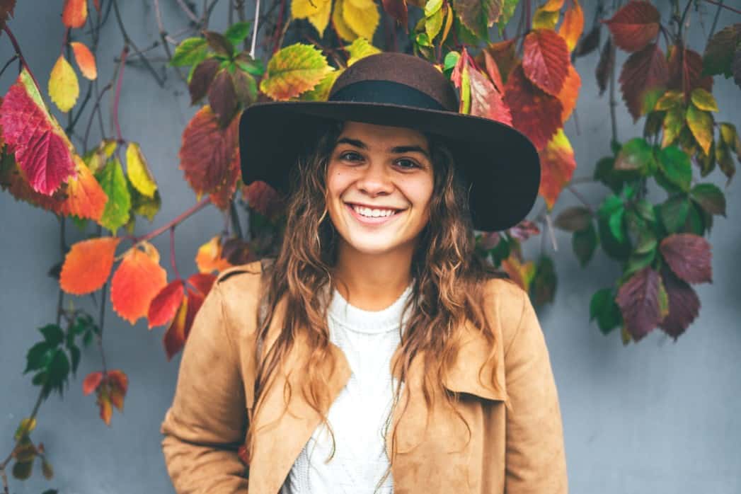 woman wearing a hat with curly hair