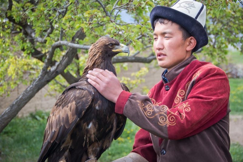 kyrgyzstan boy wearing a kalpak hat