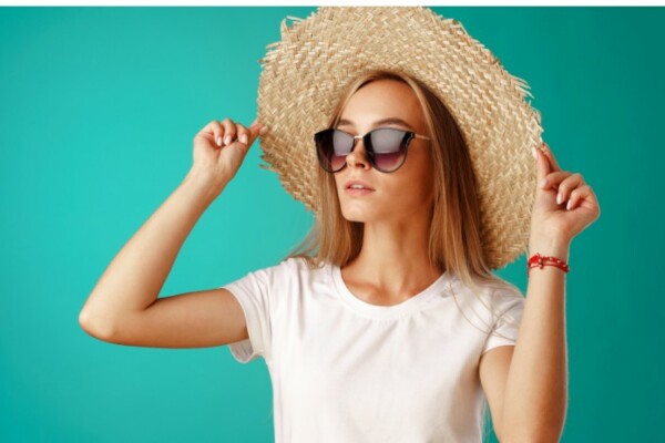 woman wearing straw floppy hat with sun glasses