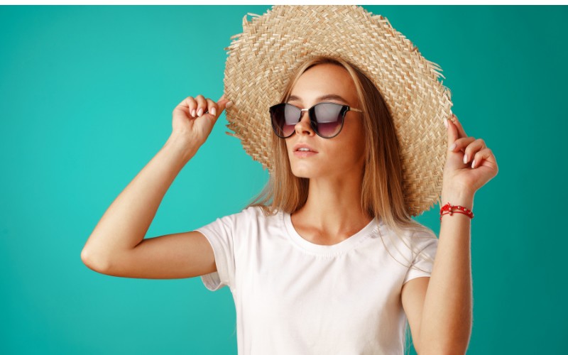 woman wearing straw floppy hat with sun glasses