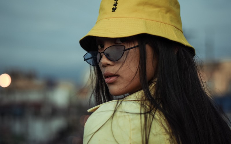 woman wearing a bucket hat with sunglasses