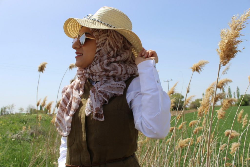 woman wearing straw hat with hijab