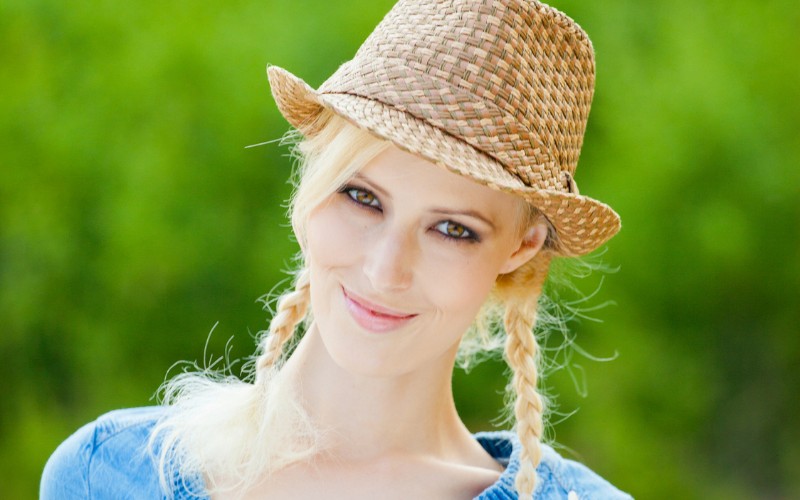 woman wearing braids with a hat