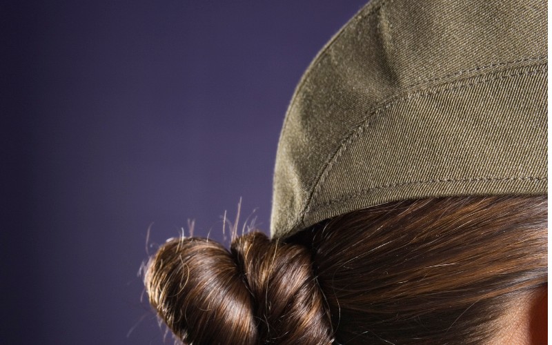 woman wearing a hat with hair bun