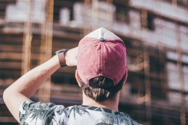 man wearing distressed baseball hat