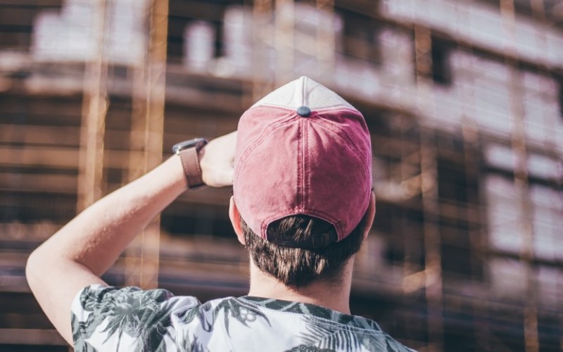 man wearing distressed baseball hat