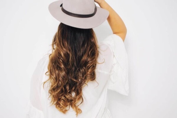 woman wearing long hair with a hat