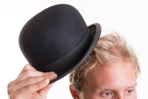 man taking off bowler hat