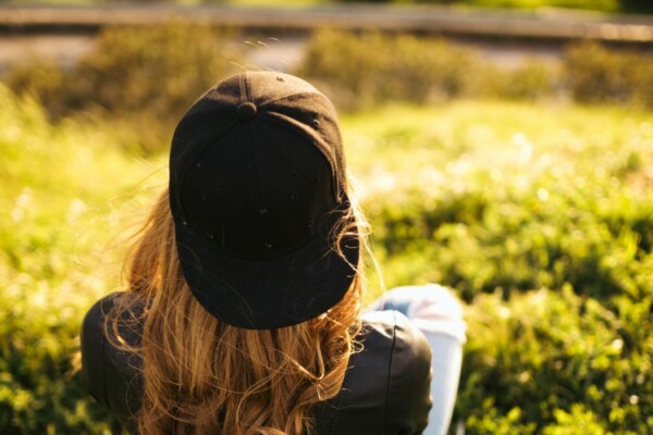 woman wearing hat backward