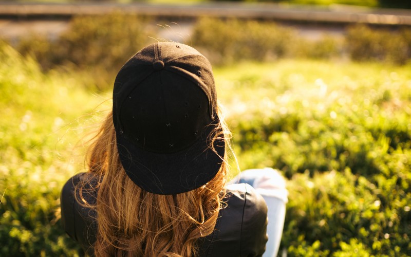 woman wearing hat backward