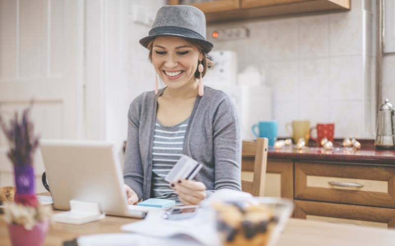 woman shopping online wearing a hat