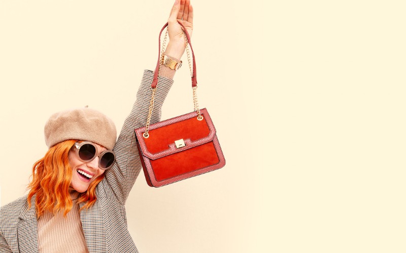 woman wearing a beret and a bag