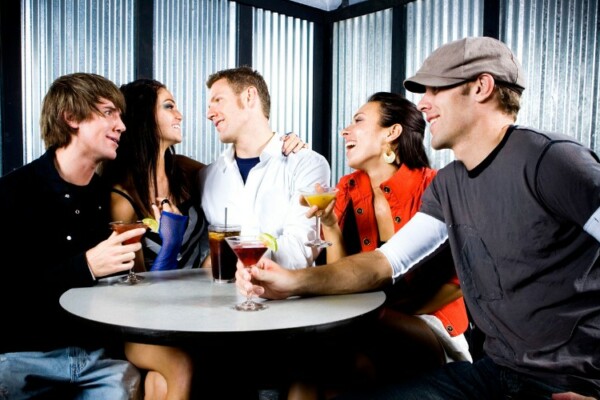 man wearing a cap in a bar