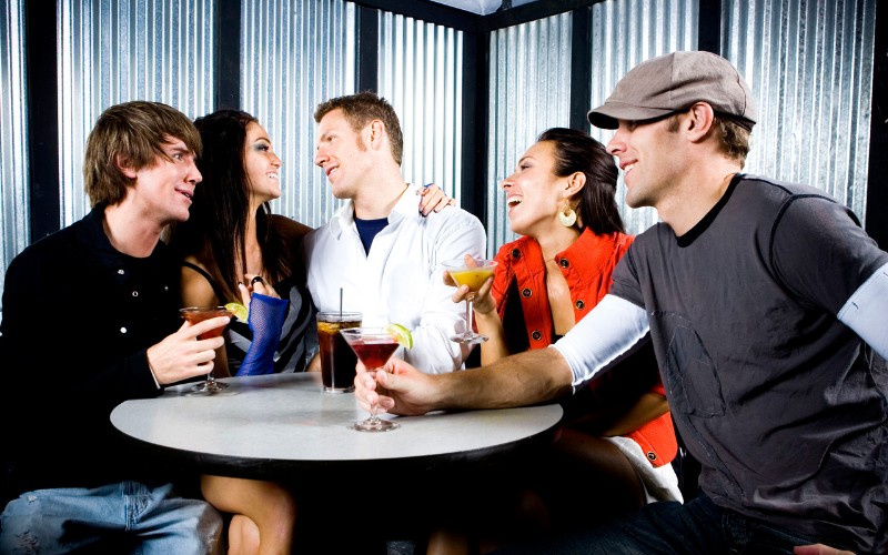 man wearing a cap in a bar