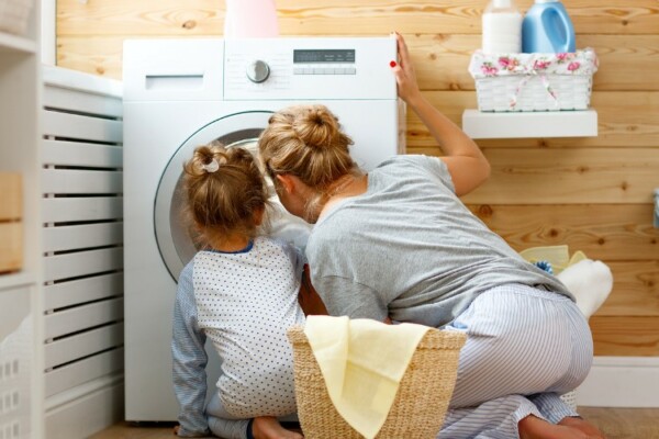 woman looking at washing machine