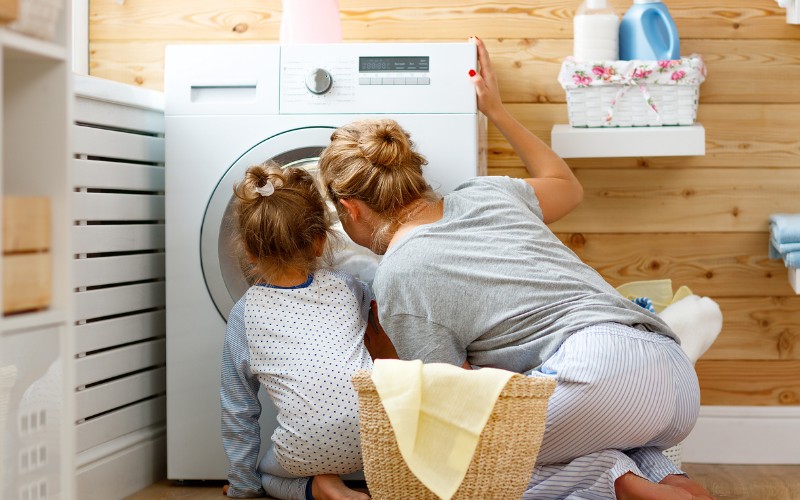 woman looking at washing machine