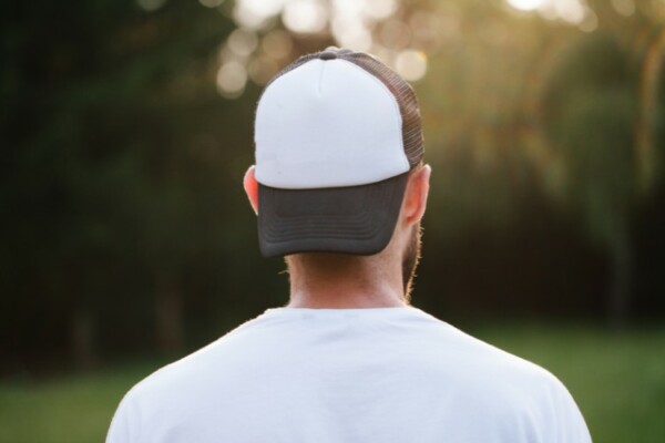 Man wearing a trucker hat backward