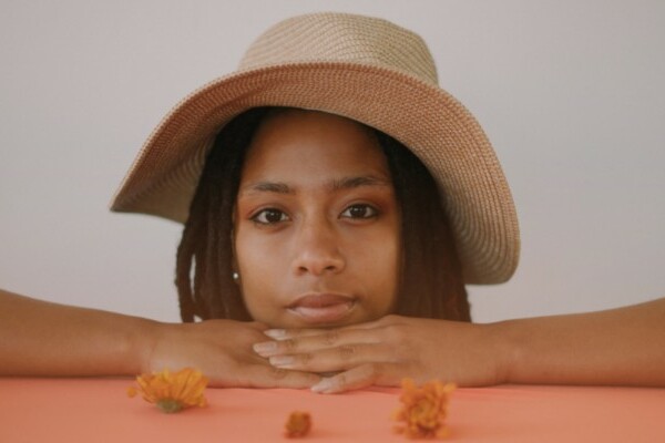 Woman with dreadlocks wearing a hat