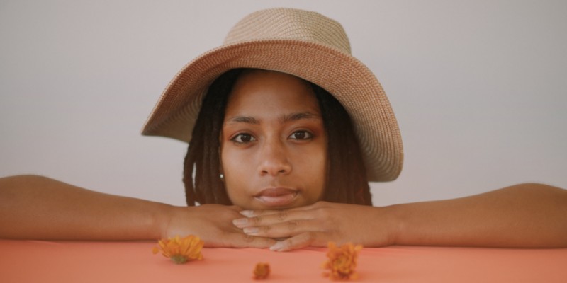 Woman with dreadlocks wearing a hat