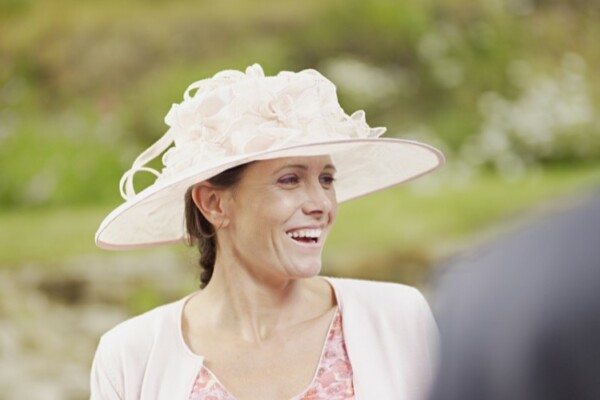 Woman wearing a hat at a wedding