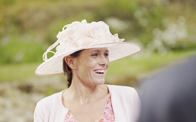 Woman wearing a hat at a wedding