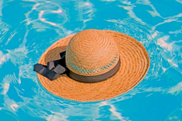 straw hat floating in a pool