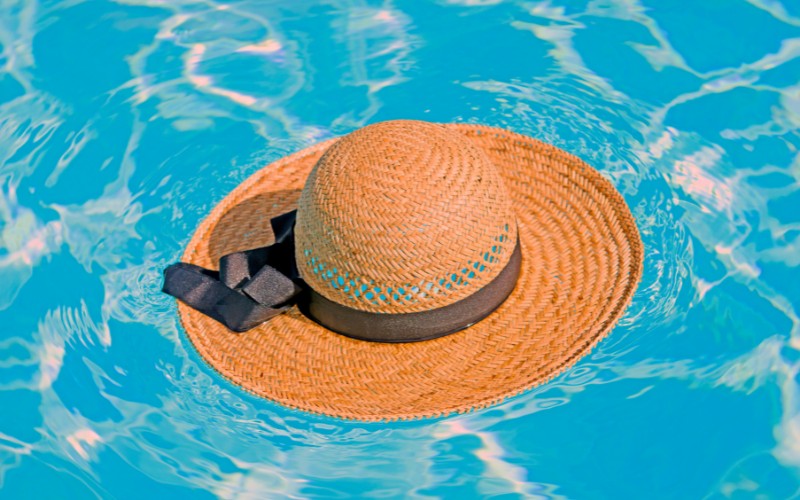 straw hat floating in a pool