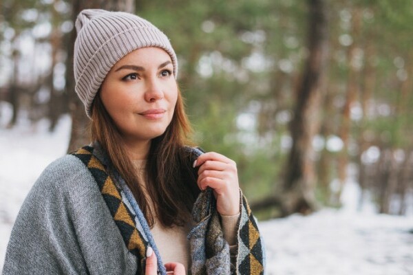 Woman wearing a winter beanie in the snow