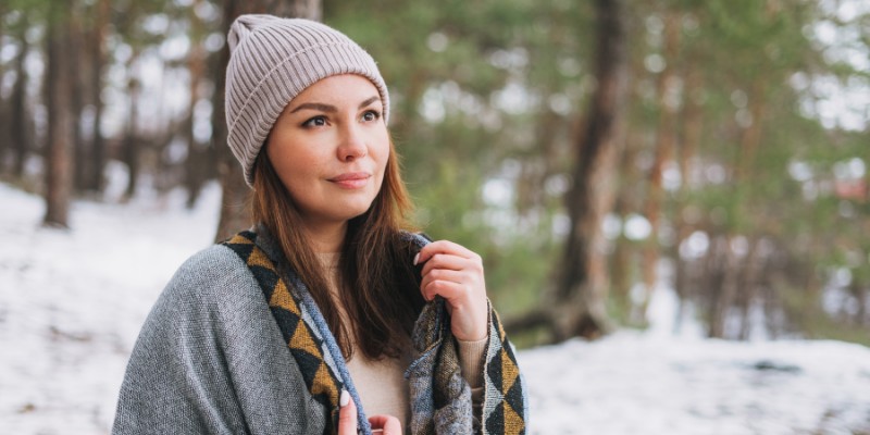 Woman wearing a winter beanie in the snow