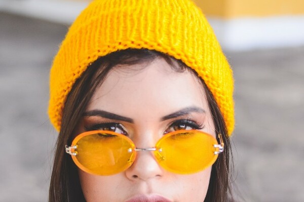 Woman wearing a beanie in the summer