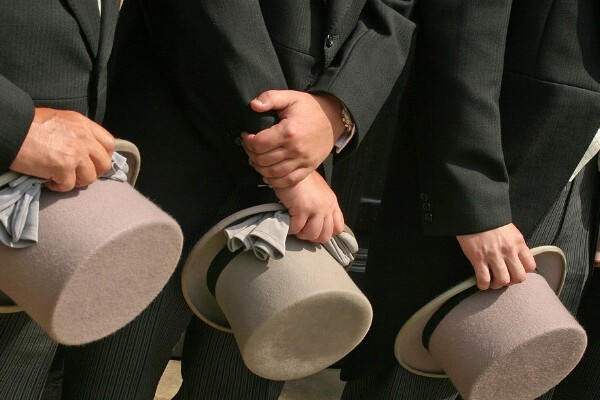 Men holding top hats