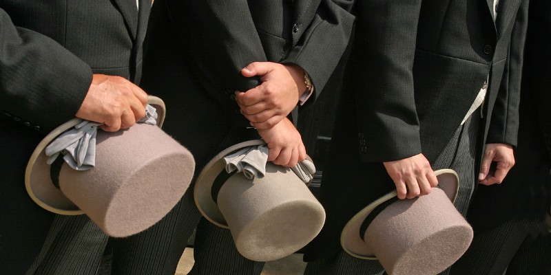 Men holding top hats