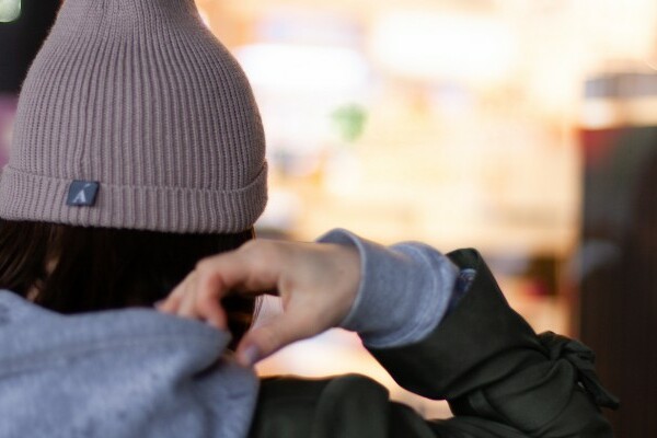 Woman wearing a grey beanie