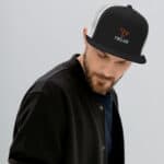 Man wearing firlark branded black and white trucker hat