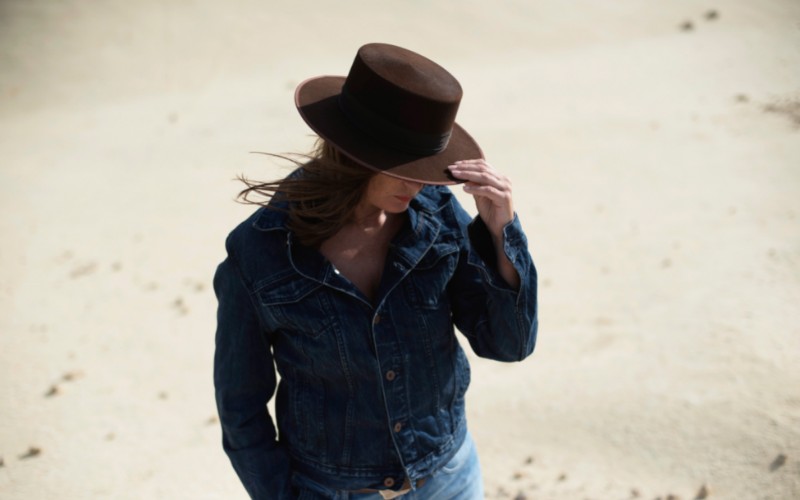 Brunette wearing a brown hat