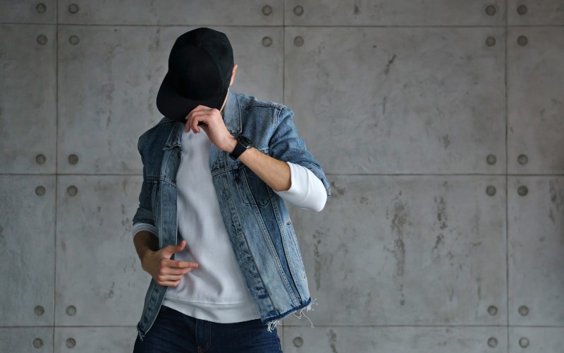 Man wearing a baseball cap low over his face