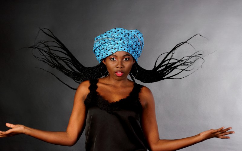 Woman with black hair and cobalt blue hat