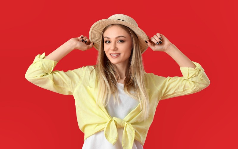 Woman sporting a boater hat with long blonde hair