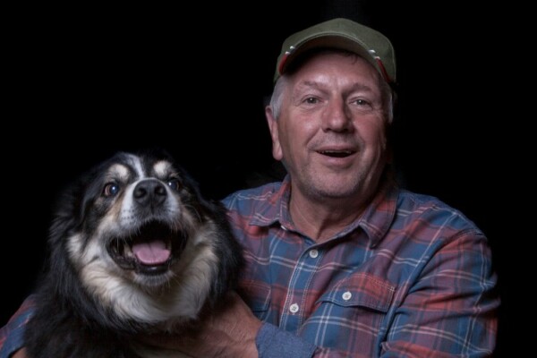 Man wearing a hat with his dog