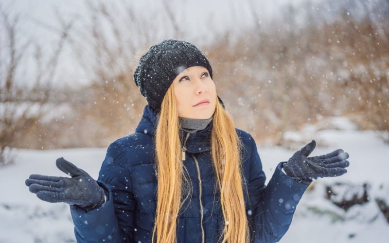 Woman wearing a black knitted beanie in the snow